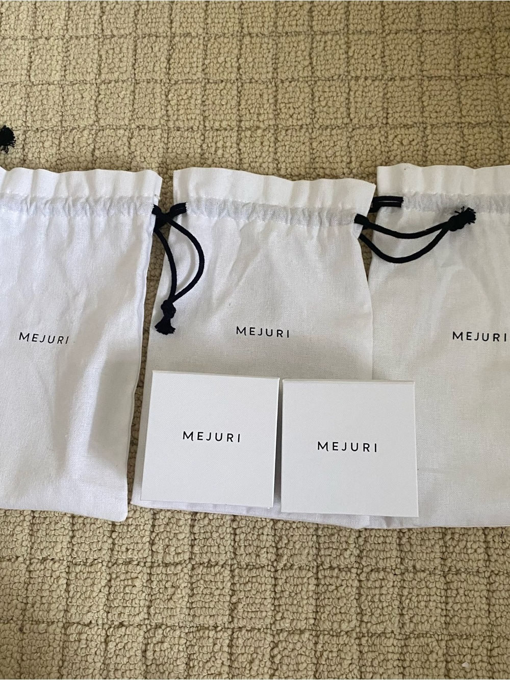 Mejuri White Drawstring Pouch and boxes